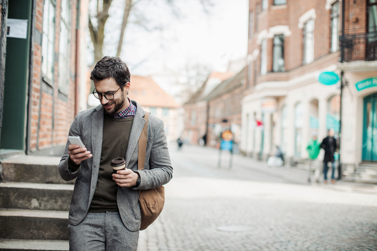 Photo of a businessman using mobile phone in the city